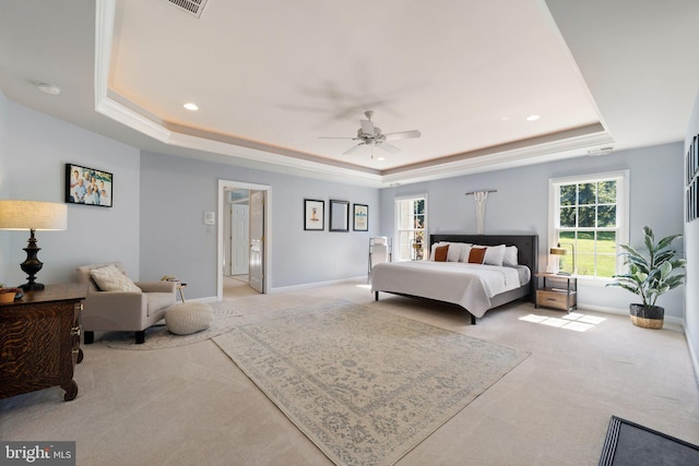 bedroom featuring ceiling fan, a raised ceiling, and light carpet