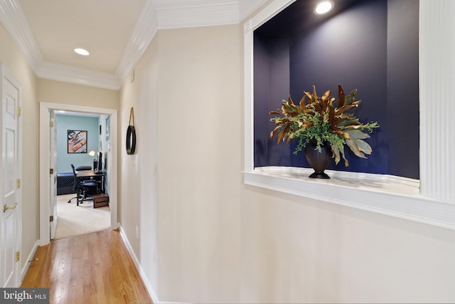 hall featuring crown molding and light hardwood / wood-style floors