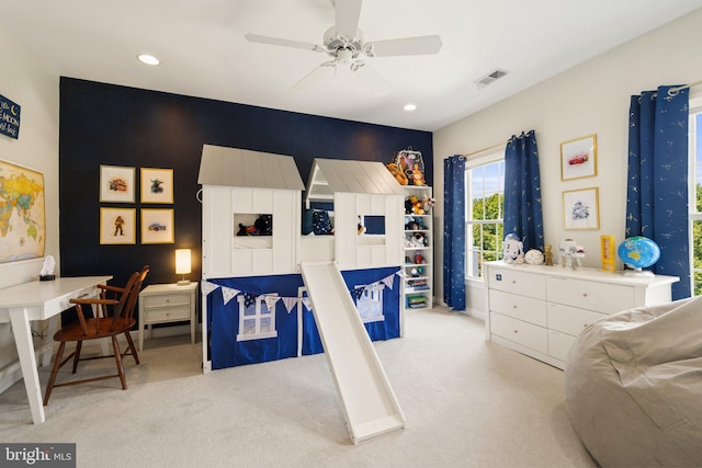 bedroom with ceiling fan and light carpet