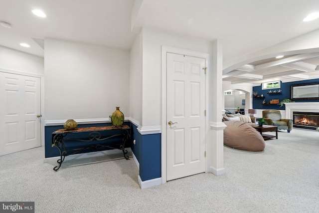 living area with coffered ceiling, carpet floors, and beamed ceiling