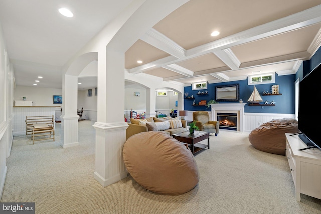 living room with decorative columns, coffered ceiling, ornamental molding, light carpet, and beamed ceiling