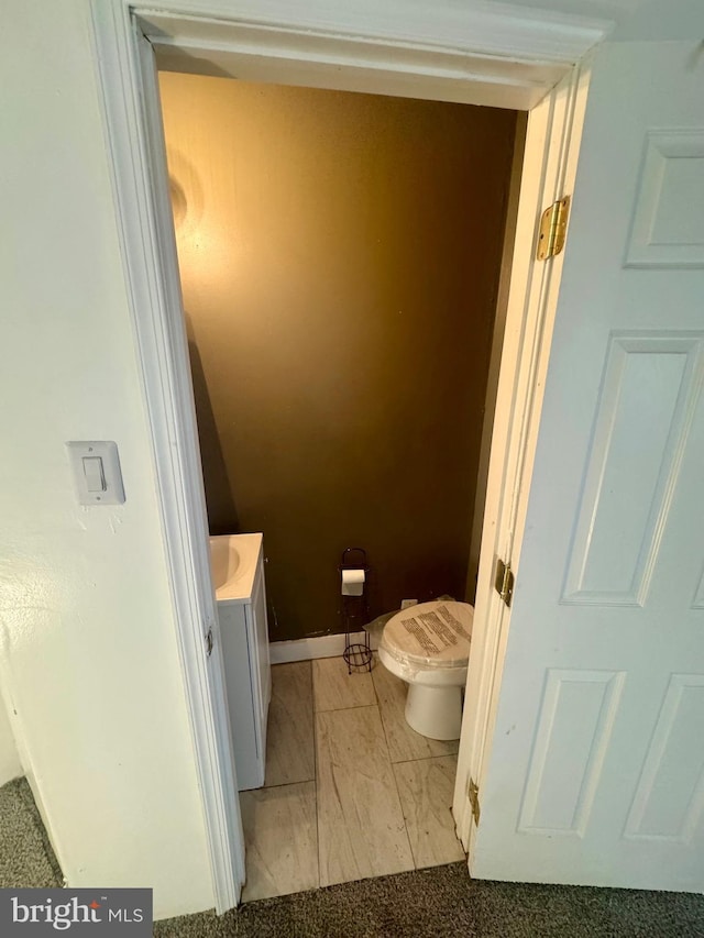 bathroom with vanity, toilet, and washer / clothes dryer