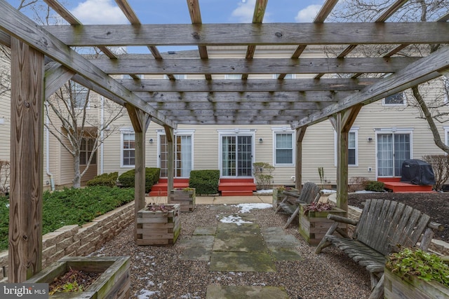 view of patio with grilling area and a pergola