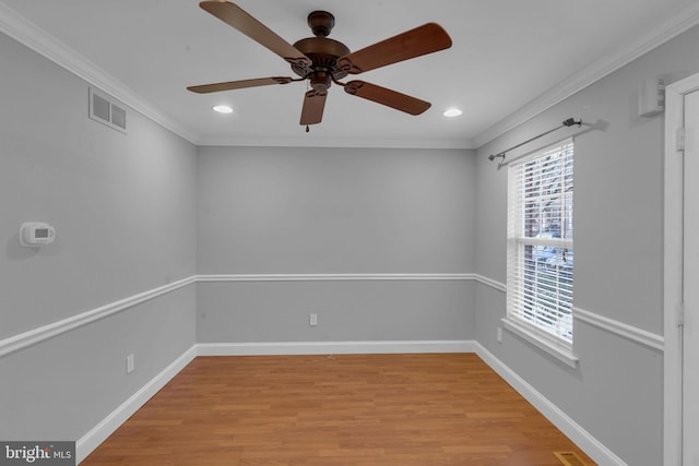 spare room featuring ceiling fan, light hardwood / wood-style flooring, and crown molding