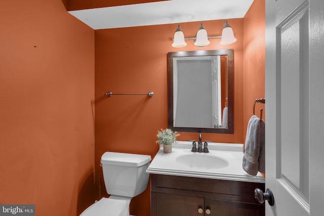 bathroom featuring toilet and vanity