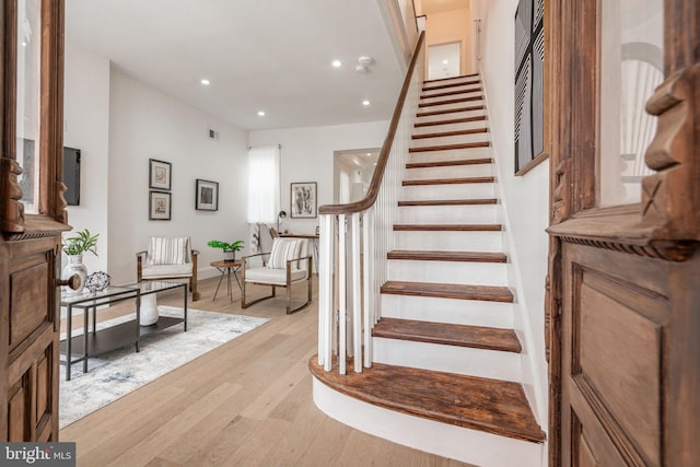 stairs featuring hardwood / wood-style flooring