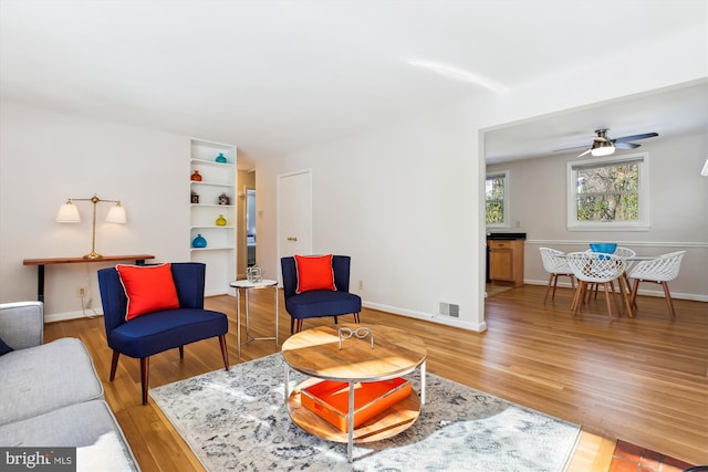 living room with ceiling fan and wood-type flooring