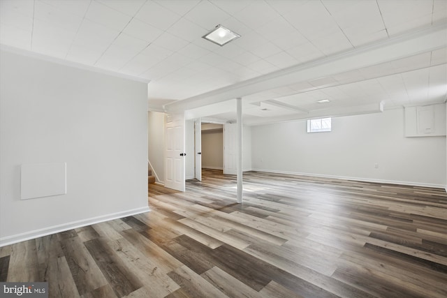 basement featuring ornamental molding and wood-type flooring