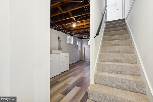 staircase with hardwood / wood-style flooring and washer and dryer