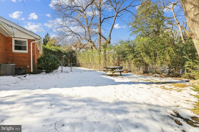 yard covered in snow featuring central air condition unit