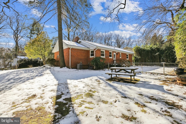 snow covered property featuring cooling unit