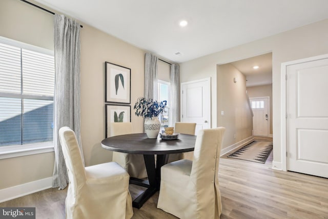 dining room with a healthy amount of sunlight and light hardwood / wood-style floors