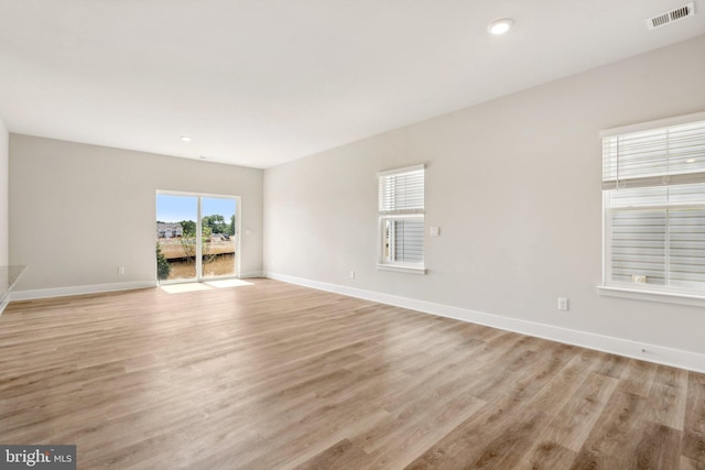 empty room with light hardwood / wood-style flooring