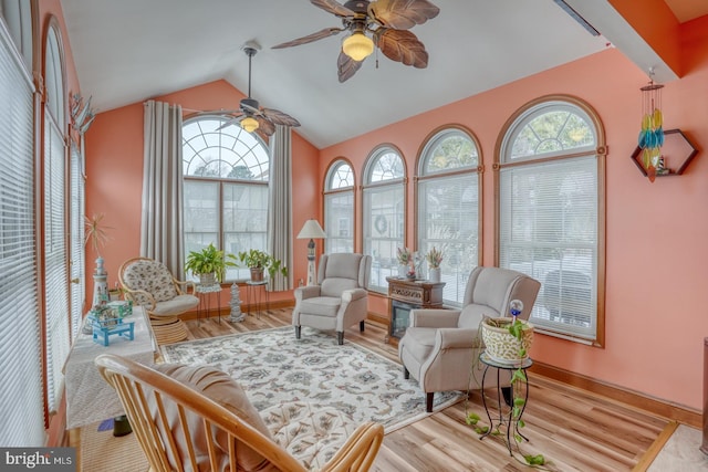 sunroom featuring ceiling fan and vaulted ceiling