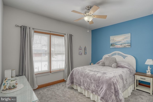 bedroom with ceiling fan, light carpet, and multiple windows