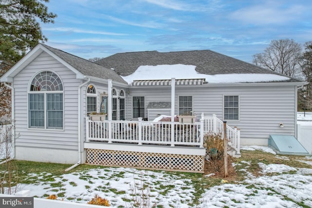 snow covered property featuring a deck