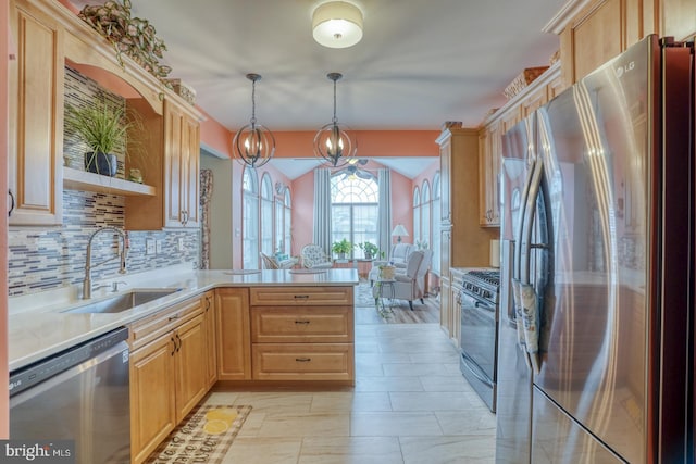 kitchen featuring tasteful backsplash, sink, hanging light fixtures, stainless steel appliances, and light brown cabinetry