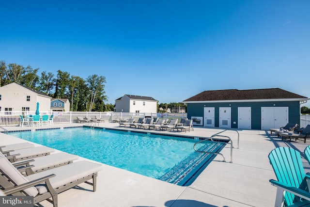 view of pool featuring a patio area and an outbuilding