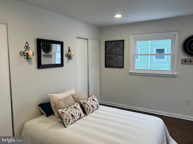 bedroom with a closet and hardwood / wood-style floors