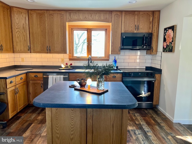 kitchen with tasteful backsplash, sink, appliances with stainless steel finishes, and dark hardwood / wood-style flooring