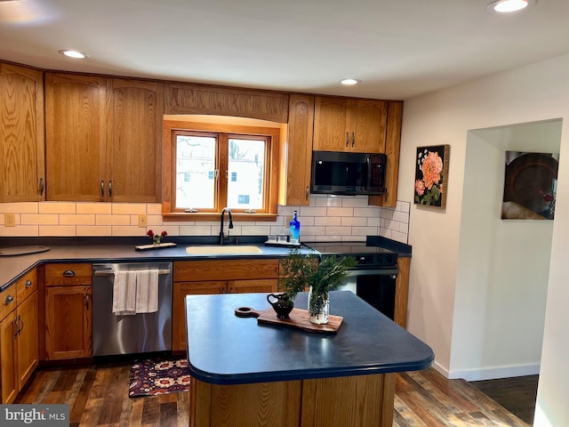 kitchen featuring dark wood-type flooring, decorative backsplash, sink, and black appliances