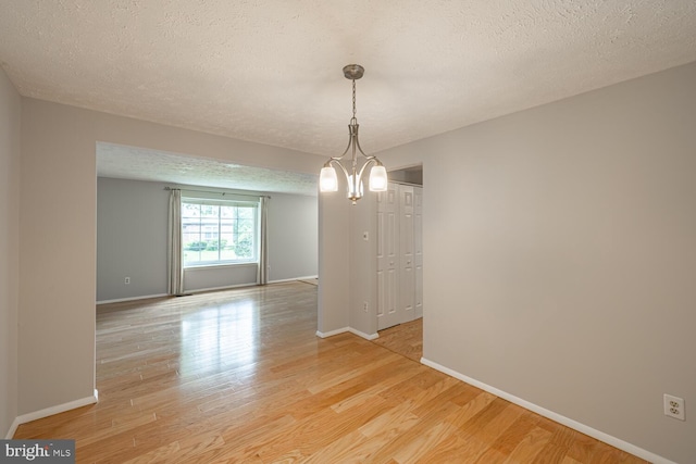 9416 Mirror Pond Dr, Fairfax, VA 22032 - empty room with light wood finished floors and a textured ceiling