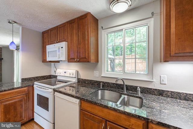 9416 Mirror Pond Dr, Fairfax, VA 22032 - kitchen with white appliances, brown cabinetry, dark stone countertops, and a textured ceiling
