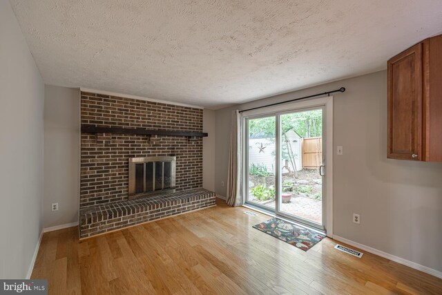 9416 Mirror Pond Dr, Fairfax, VA 22032 - unfurnished living room with a textured ceiling, wood finished floors, and a fireplace