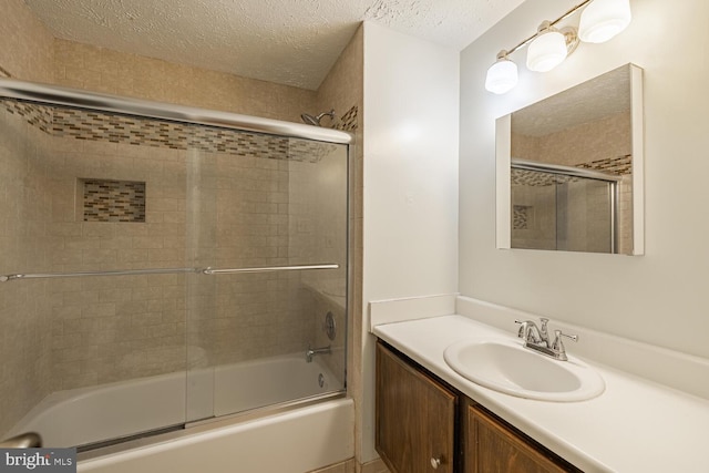 9416 Mirror Pond Dr, Fairfax, VA 22032 - bathroom with a textured ceiling, vanity, and combined bath / shower with glass door