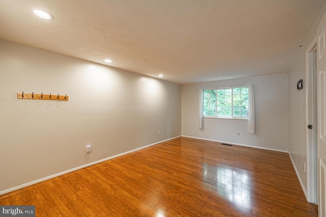 9416 Mirror Pond Dr, Fairfax, VA 22032 - empty room with a textured ceiling, wood finished floors, and recessed lighting