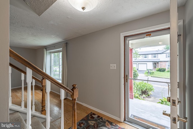 9416 Mirror Pond Dr, Fairfax, VA 22032 - foyer with a textured ceiling, stairs, and wood finished floors