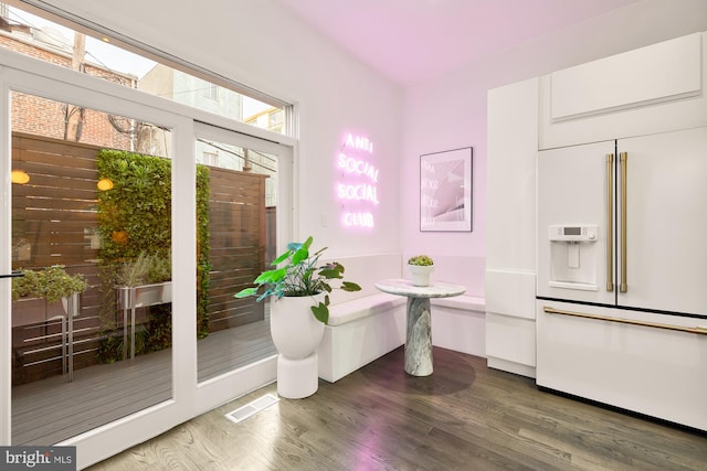 interior space with breakfast area and hardwood / wood-style flooring