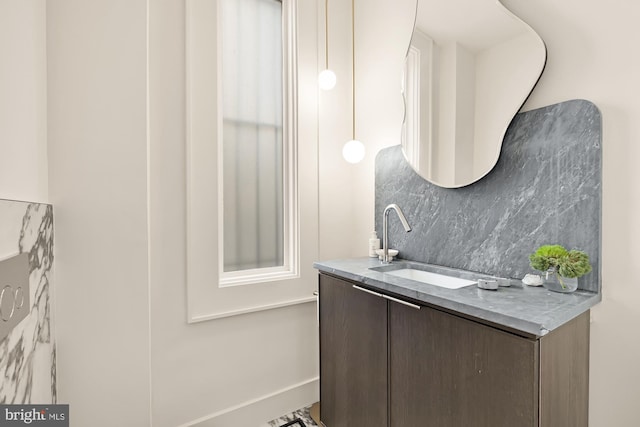 bathroom featuring tasteful backsplash and vanity