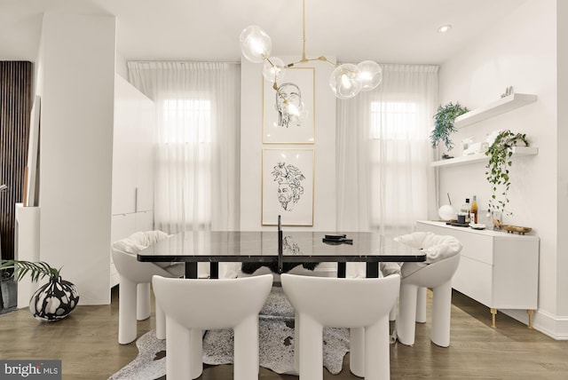 dining area featuring hardwood / wood-style flooring and a healthy amount of sunlight