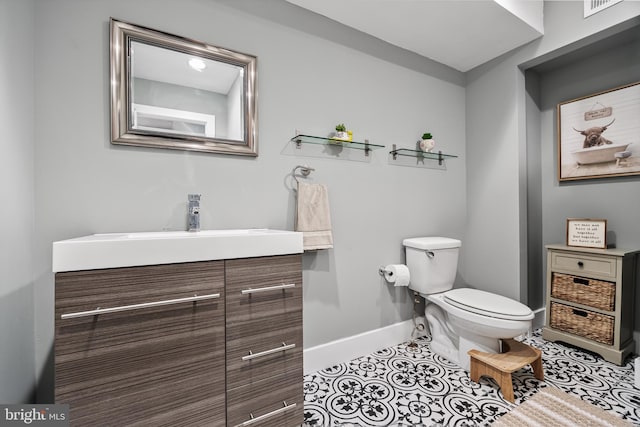 bathroom featuring vanity, tile patterned floors, and toilet