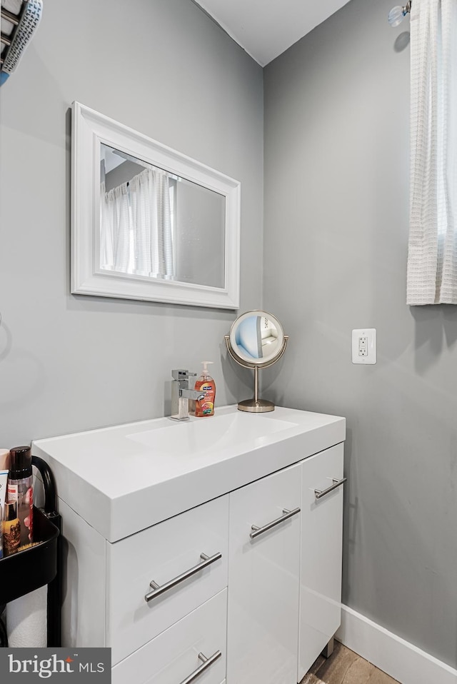 bathroom with vanity and hardwood / wood-style floors