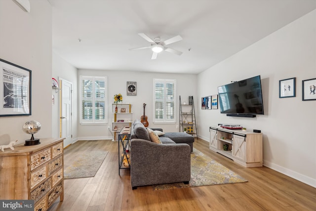 living room with ceiling fan and light wood-type flooring