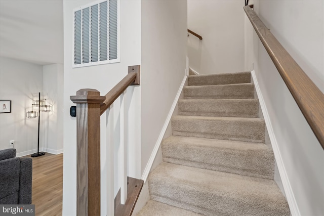 stairway featuring wood-type flooring