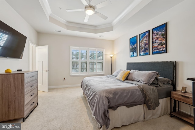 carpeted bedroom featuring crown molding, ceiling fan, and a tray ceiling