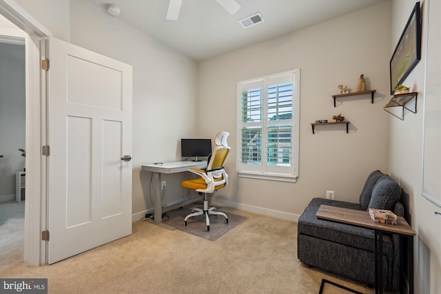 carpeted office space featuring ceiling fan