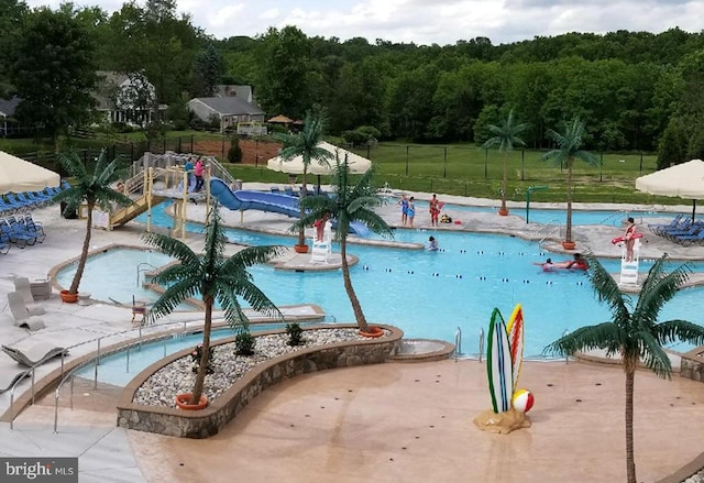 view of swimming pool featuring a yard and a patio area