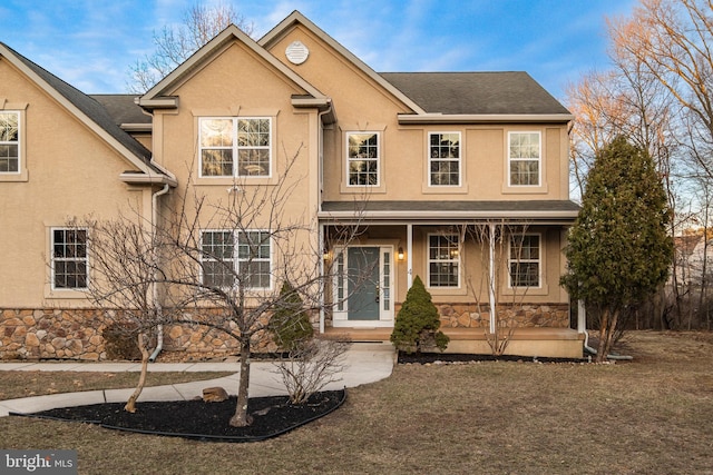 view of property with a porch and a front yard