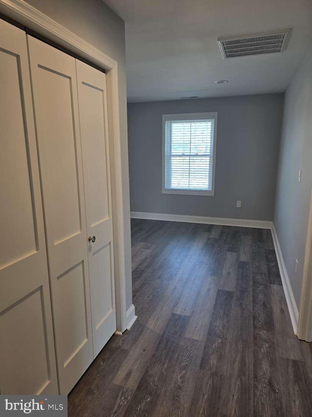 hallway with dark hardwood / wood-style floors