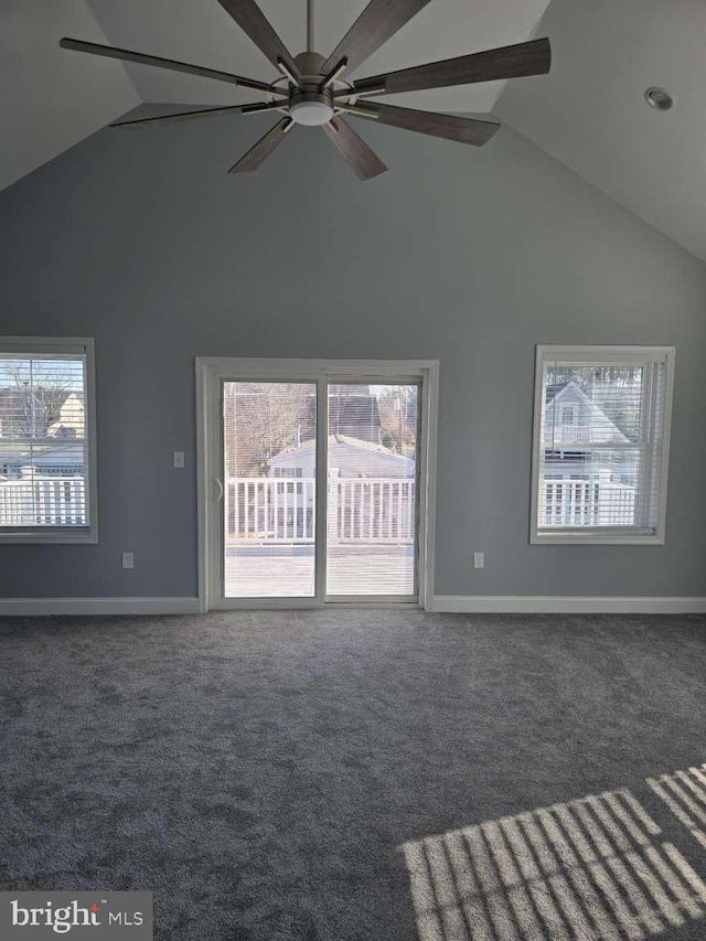 unfurnished living room featuring ceiling fan, high vaulted ceiling, and dark carpet