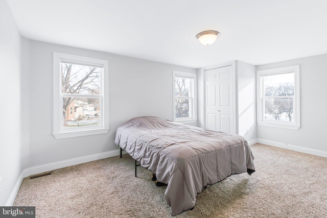 carpeted bedroom with a closet