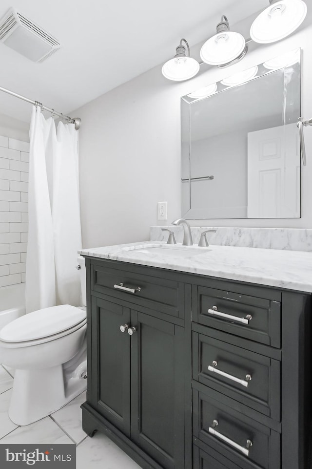 full bathroom with shower / tub combo, vanity, and toilet