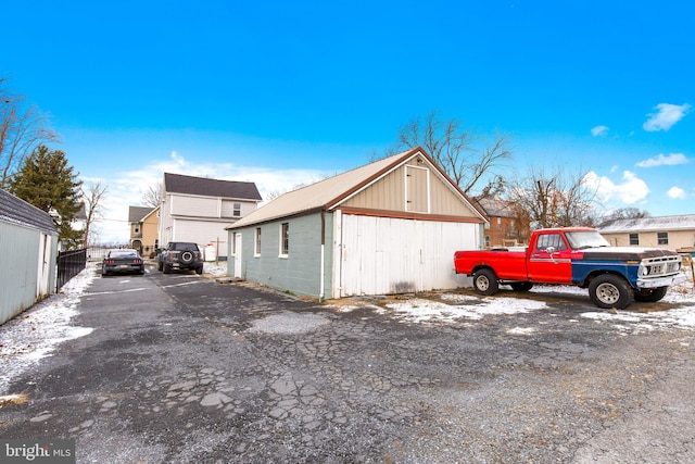 view of side of home featuring an outbuilding and a garage