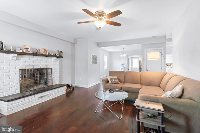 living room with ceiling fan, a fireplace, and dark hardwood / wood-style floors