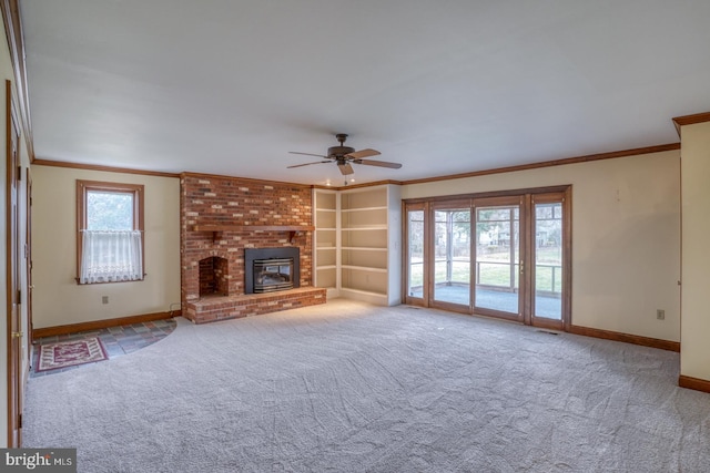 unfurnished living room with light carpet, a fireplace, ceiling fan, and ornamental molding