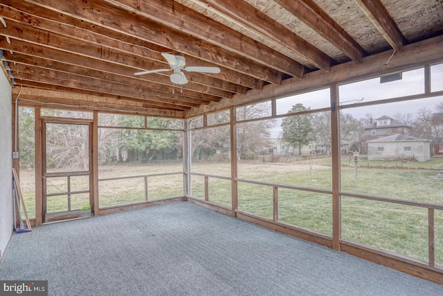 unfurnished sunroom featuring a wealth of natural light and ceiling fan